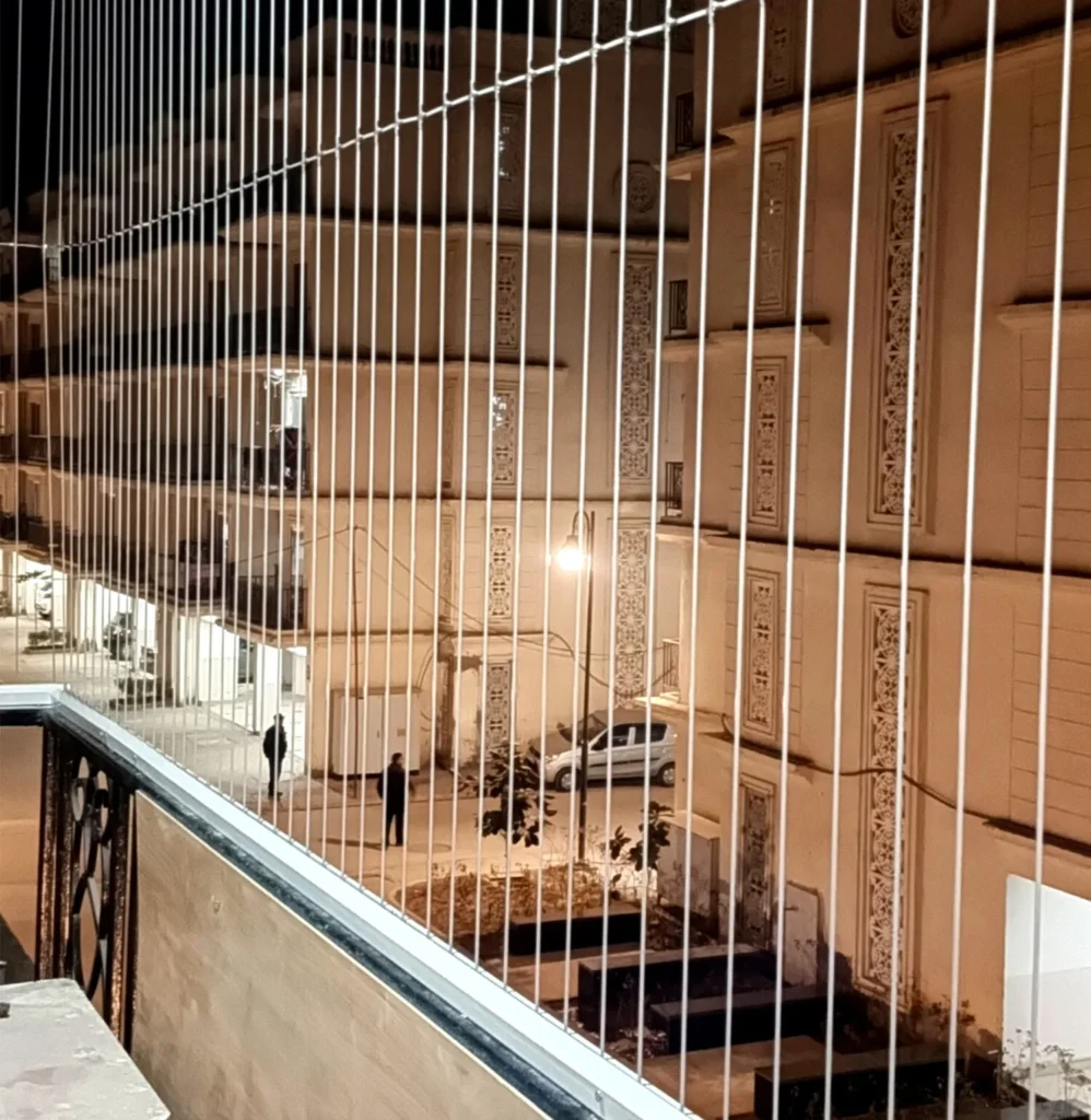 Invisible balcony safety grill installed in a modern apartment
